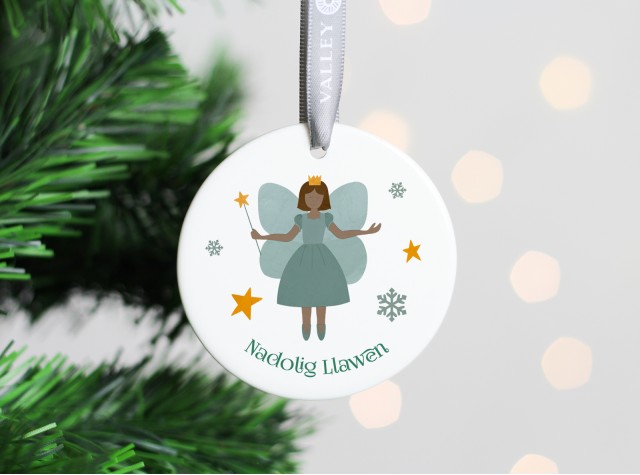 White ceramic christmas tree decoration with the image of a cute fairy